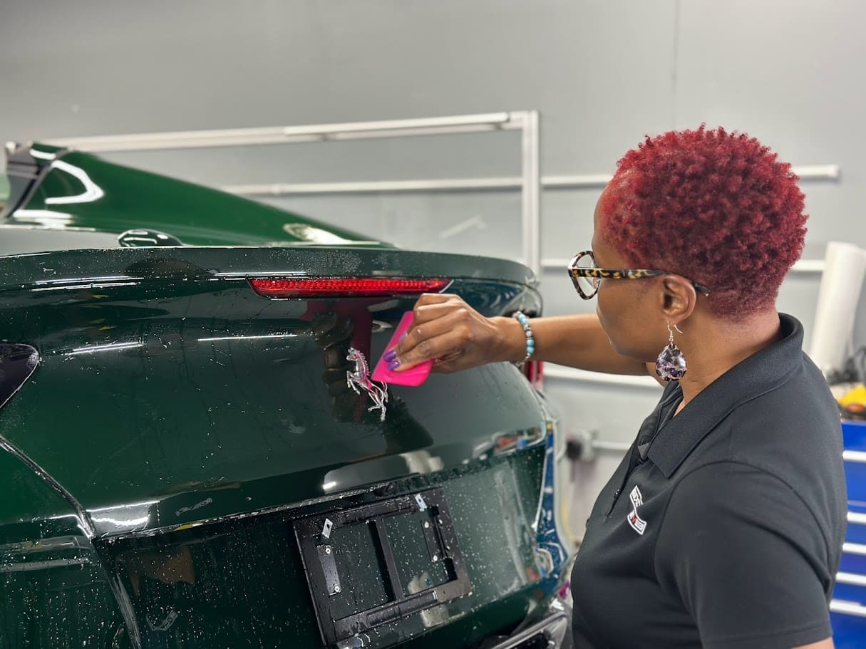 Applying paint protection film to Ferrari Prancing Horse emblem on 2024 Ferrari 812 Superfast at Exclusive Paint Protection Charlotte