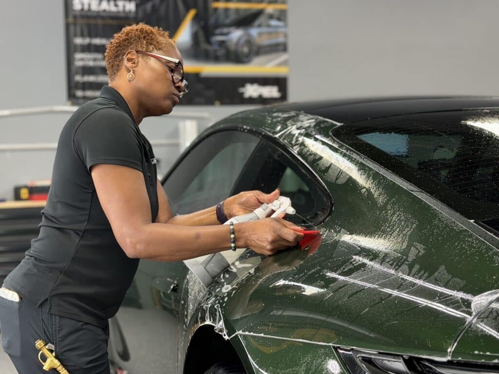 Exclusive Paint Protection installer applying full body XPEL Ultimate Plus paint protection film to a green 2026 Porsche 911 Carrera 4S in Charlotte, NC