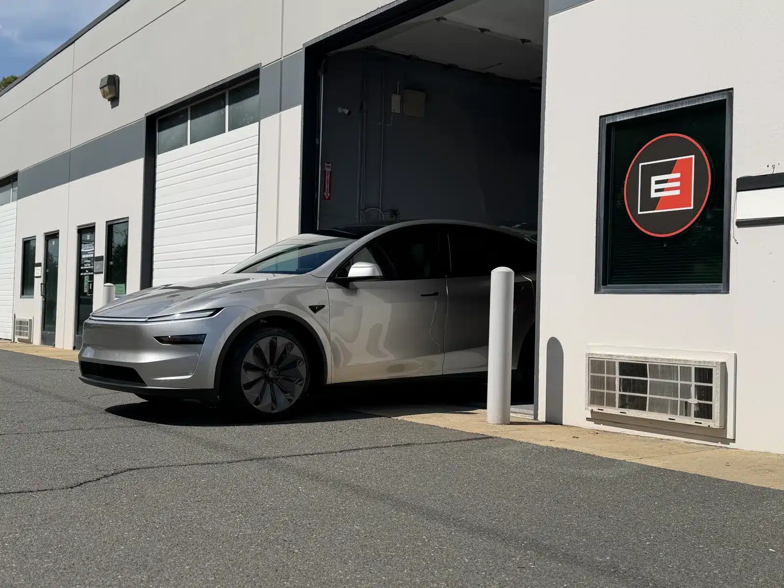 Silver Tesla Model Y L with XPEL PRIME XR PLUS ceramic window tint leaving Exclusive Paint Protection's Charlotte studio